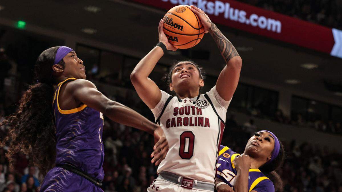 University of South Carolina’s Te-Hina Paopao (0) shoots as Louisiana State University’s Flau’Jae Johnson (4) and Aneesah Morrow (24) pressure during the second half of action in the Colonial Life Arena on Friday, Jan. 24, 2025.