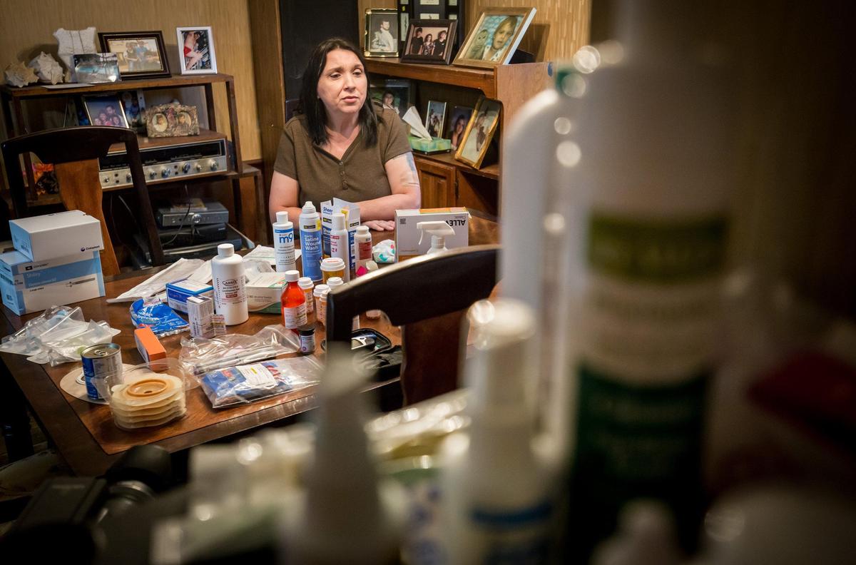 Becky Kelly, Jodie Roberts’ aunt, talks near a table of medicine and other medical supplies for Roberts. She is in a vegetative state after being without oxygen for roughly twenty minutes while giving birth to her son in July 2018.