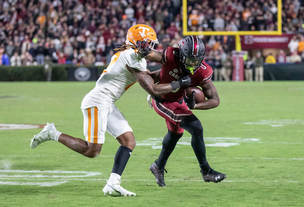 South Carolina Gamecocks tight end Jaheim Bell (0) fends off the tackle of Tennessee Volunteers defensive back Tamarion McDonald (12) at Williams-Brice Stadium in Columbia, SC on Saturday, Nov. 19, 2022.