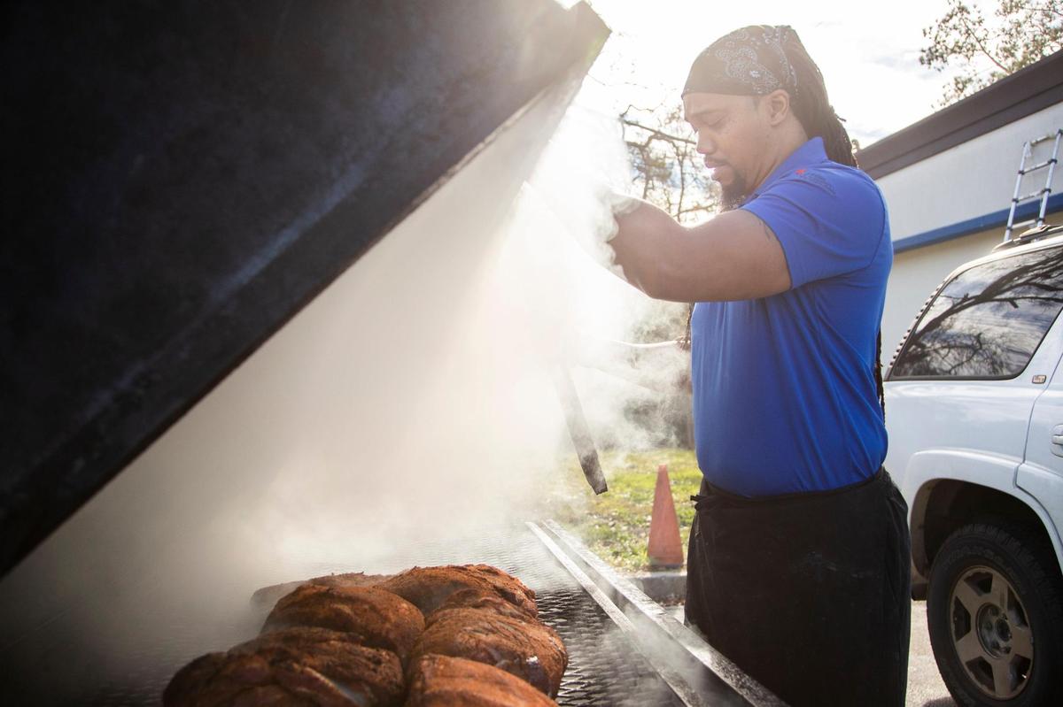 Chris Williams smokes brisket and pork at his restaurant, Roy’s Grille, located at a gas station in Lexington, South Carolina on Friday, January 7, 2022.
