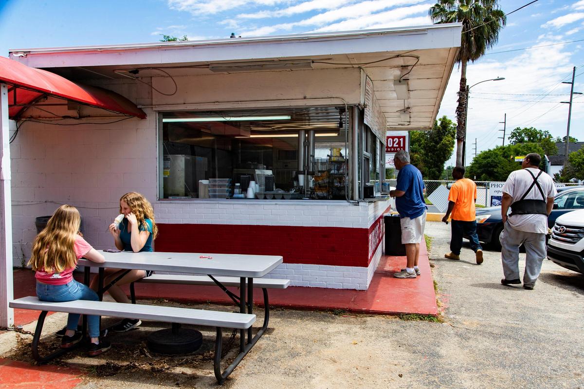 Customers wait for their orders outside the Rosewood Dairy Bar on Monday, May 4, 2020. 