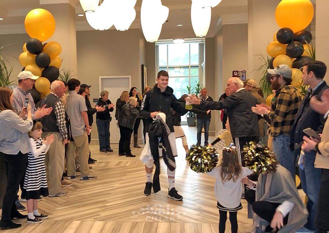 Fans cheer on Fletcher Magee and the Wofford basketball team as they leave the Hilton Garden Inn for the Southern Conference Tournament.