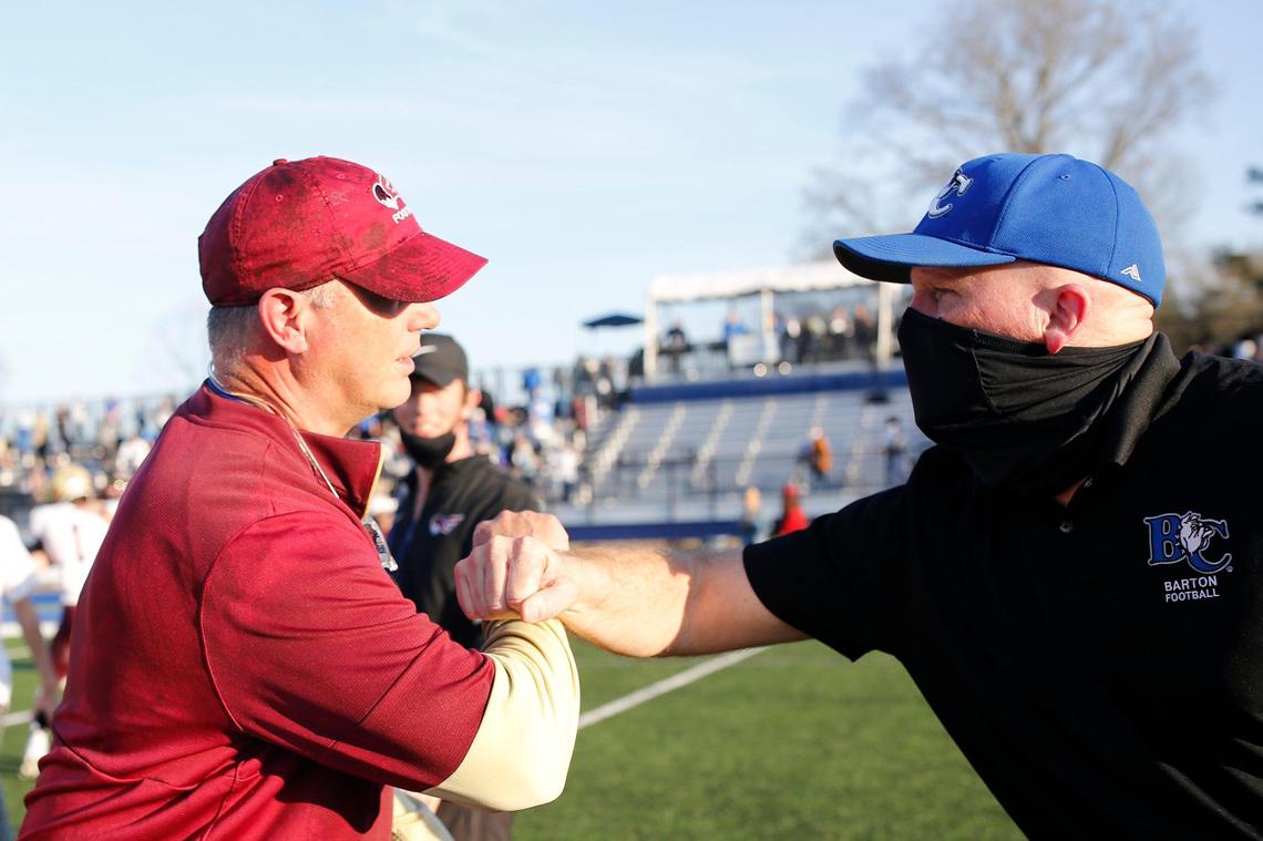 Erskine head coach Shap Boyd, left, and Barton head coach Chip Hester, right, meet after the game Saturday.
