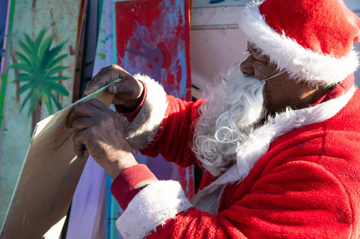 Ernest Lee sells his famous Chicken Man and other paintings on Gervais Street on Friday, December 15, 2022. Lee’s artwork is widely collected, and some collectors give the paintings as gifts.