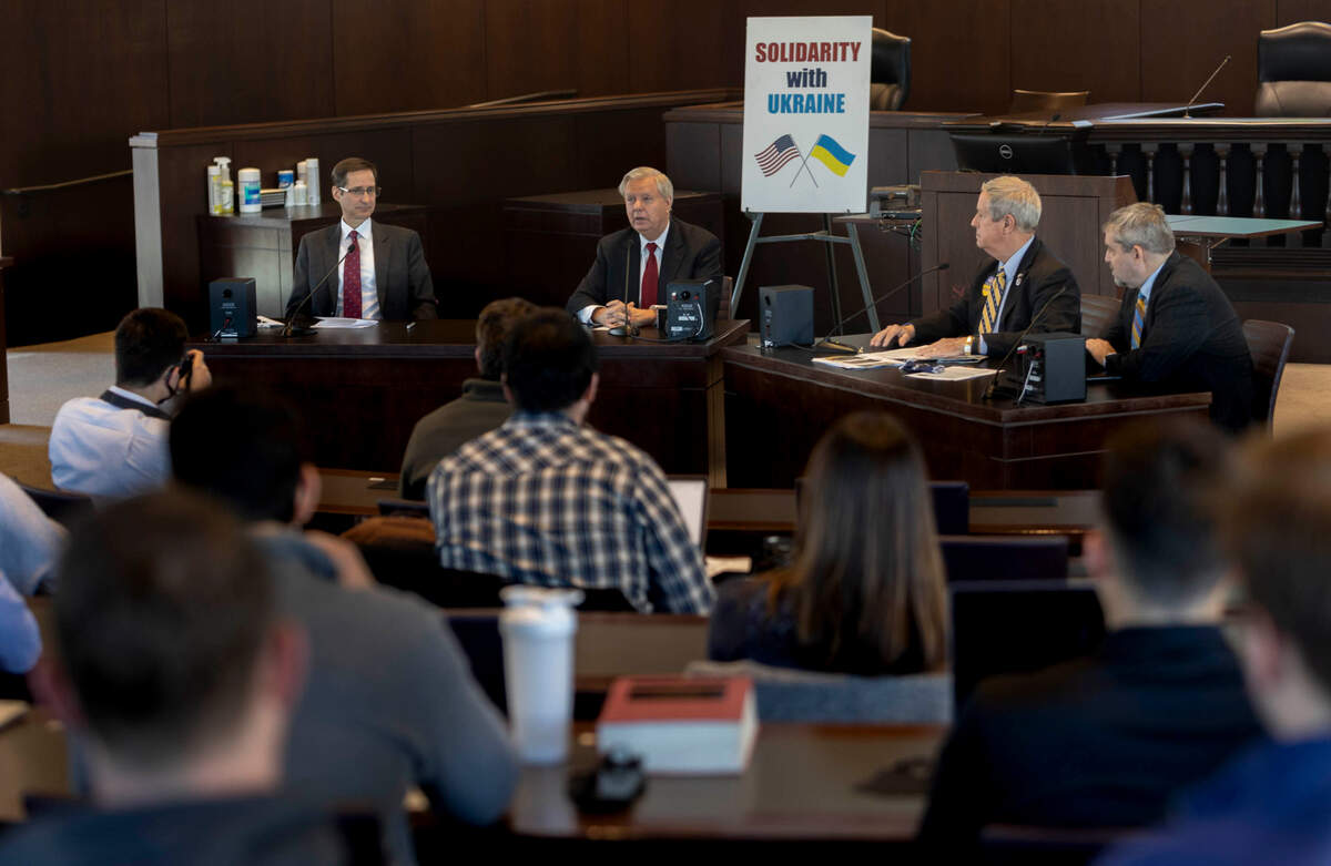 Steven Austermiller, Deputy Executive Director, Rule of Law Collaborative, from left, U.S. Sen. Lindsey Graham, U.S. Rep. Joe Wilson, and Joel H. Samuels, Dean, College of Arts & Sciences and Executive Director, gather for a roundtable discussion about Ukraine on Monday, March, 14, 2022. The event took place at the University of South Carolina School of Law.