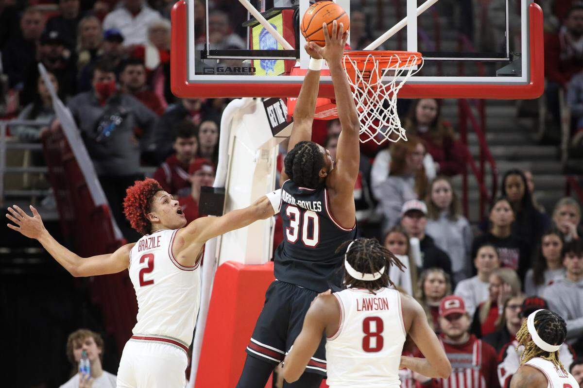 Jan 20, 2024; Fayetteville, Arkansas, USA; South Carolina Gamecocks forward Collin Murray-Boyles (30) dunks the ball in the first half as Arkansas Razorbacks forward Trevon Brazile (2) defends at Bud Walton Arena. Mandatory Credit: Nelson Chenault-USA TODAY Sports