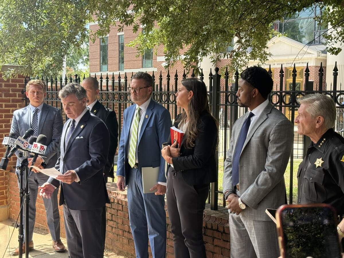 U.S. Attorney Bryan Stirling speaks to reporters while (left to right) are federal prosecutors Elliott Daniels, from left, Lance Crick, Elle Klein, Lamar Fyall and Richland County Sheriff Leon Lott look on. FBI agent Luke Davis is obscured behind Stirling.