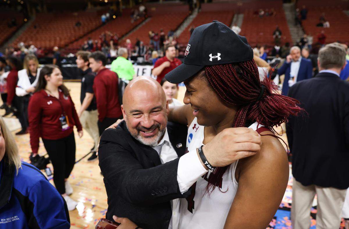 South Carolina Gamecocks forward Aliyah Boston (4) celebrates with assistant coach Fred Chmiel following their team’s win over Maryland in the Elite 8 round of the 2023 NCAA Tournament at Bon Secours Wellness Arena in Greenville on Monday, March 27, 2023.