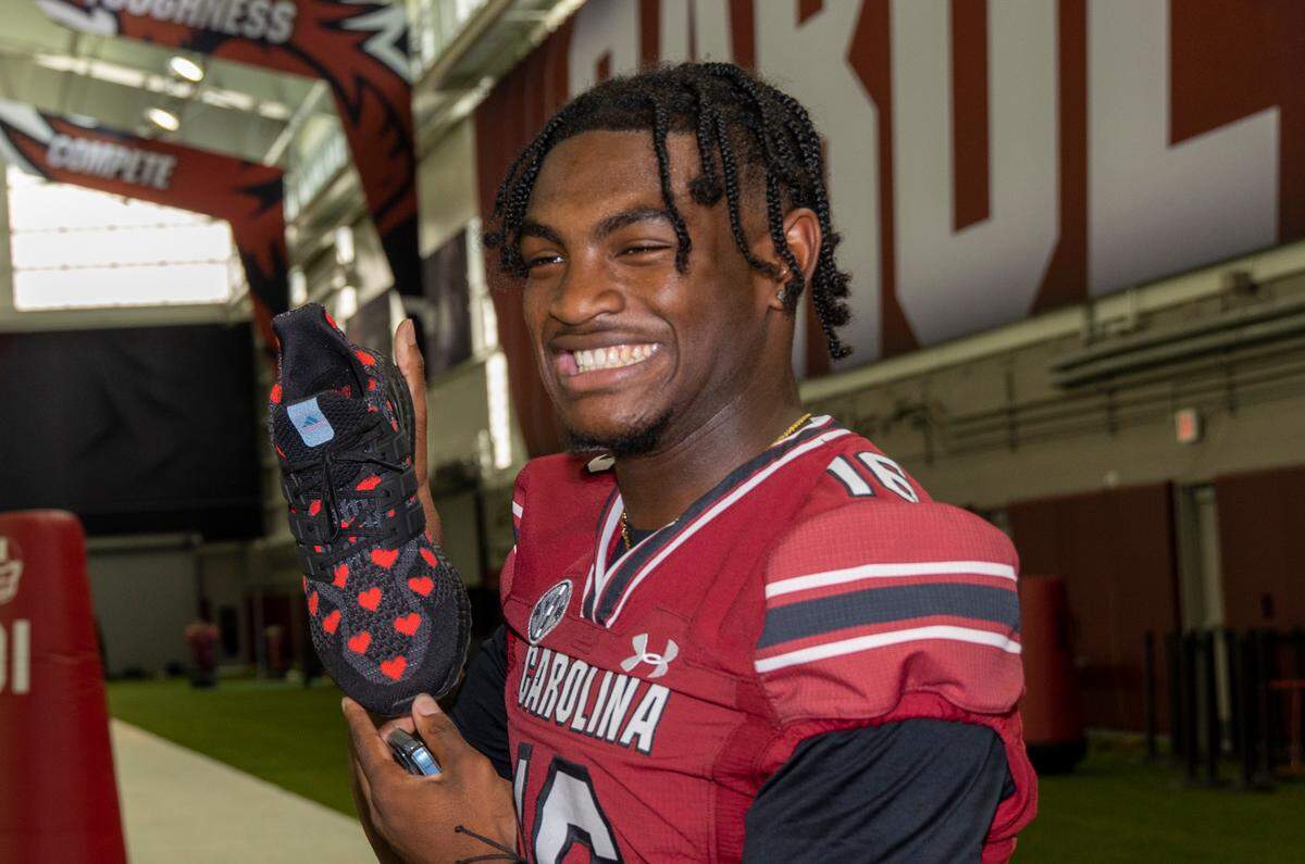 Corey Rucker shows off his shoes during team media day on Thursday, Aug. 4, 2022 in the Jerri and Steve Spurrier Indoor Practice Facility.