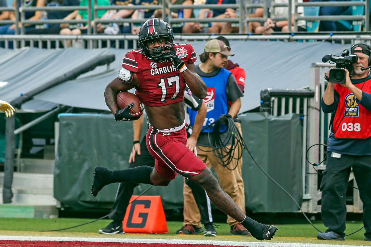South Carolina wide receiver Xavier Legette (17) runs the ball in for a touchdown after a catch during the first quarter of the Gator Bowl NCAA college football game against Notre Dame on Friday, Dec. 30, 2022, in Jacksonville, Fla. (AP Photo/Gary McCullough)