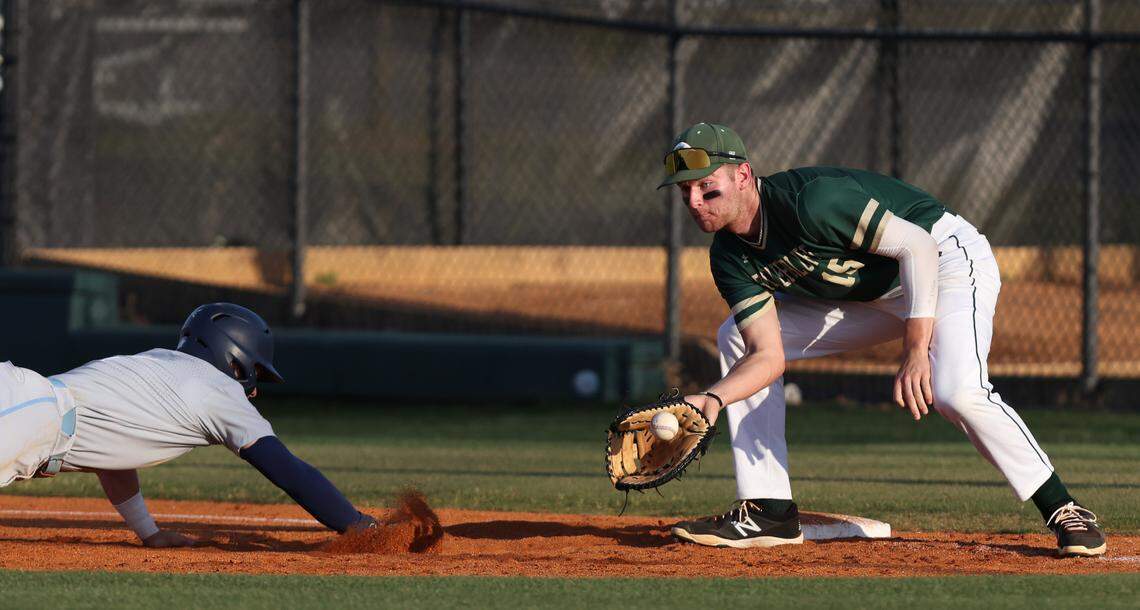 Maddox Floyd (2) of Chapin dives safely into first, ahead of the tag by Beau Hollins (15) of River Bluff during River Bluff’s game against Chapin in Lexington on Friday, April 28, 2023.