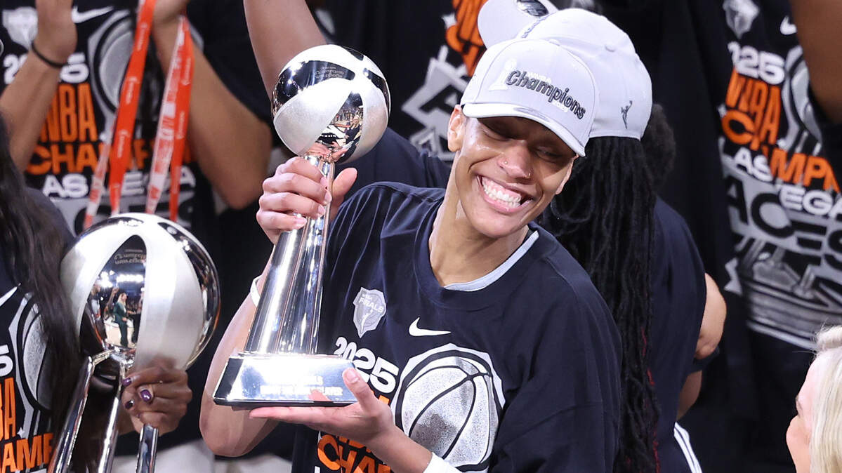 PHOENIX, ARIZONA - OCTOBER 10: A'ja Wilson #22 of the Las Vegas Aces celebrates with the Most Valuable Player award after winning game four of the 2025 WNBA Playoffs finals at Mortgage Matchup Center on October 10, 2025 in Phoenix, Arizona. The Las Vegas Aces defeat the Phoenix Mercury 97-86 to win the championship. NOTE TO USER: User expressly acknowledges and agrees that, by downloading and or using this photograph, User is consenting to the terms and conditions of the Getty Images License Agreement.  (Photo by Chris Coduto/Getty Images)