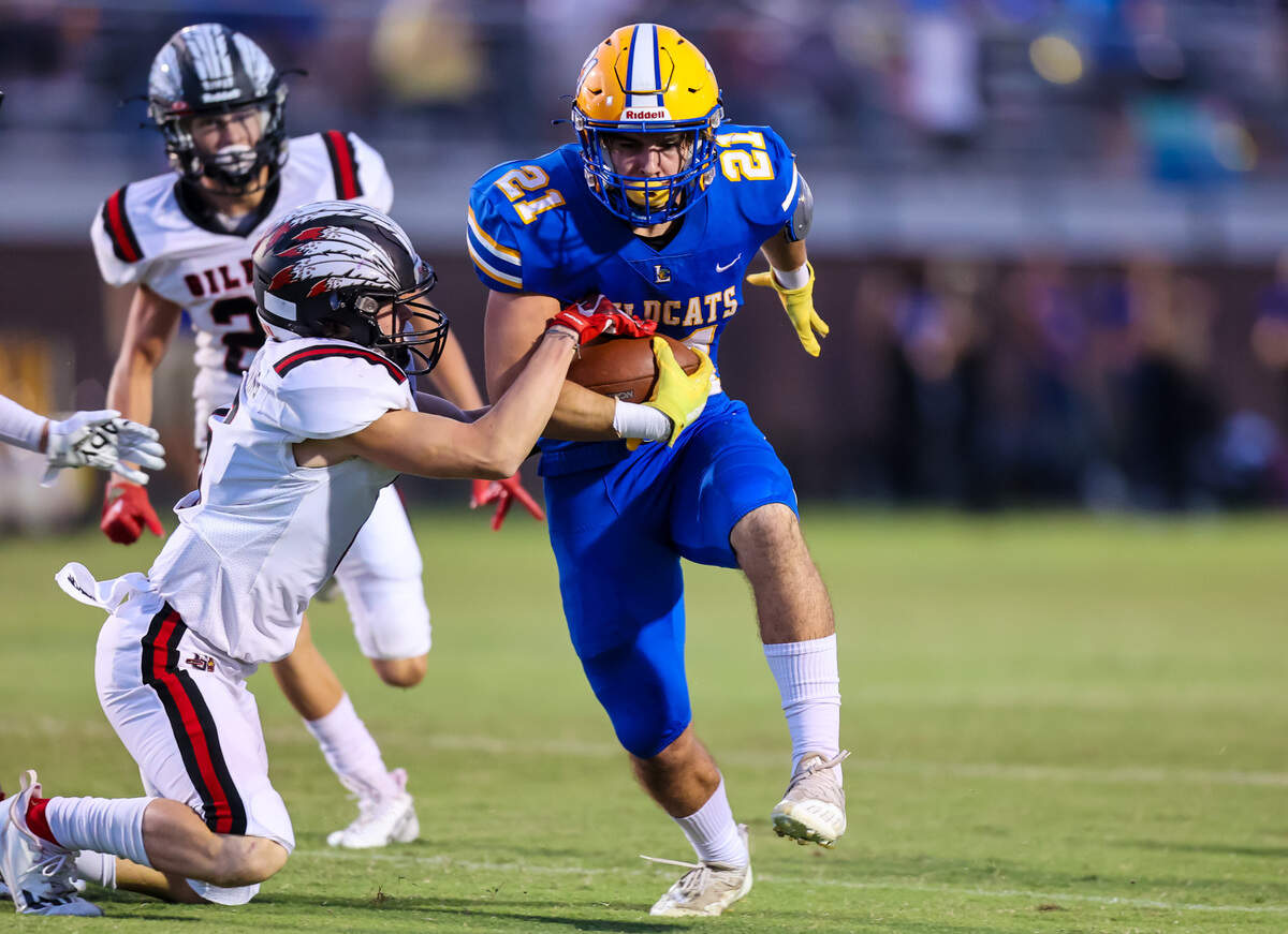 Lexington Wildcats Jonah Norris (21) rushes past Gilbert Indians CJ Browning (6) during their game at Lexington High School Friday, Sept. 16, 2022.