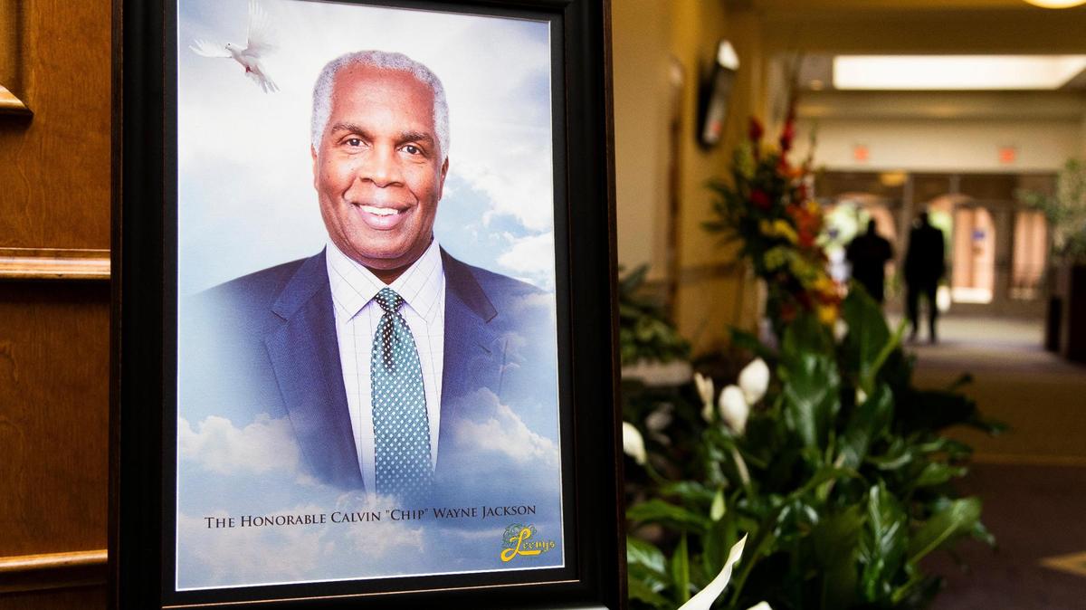 A portrait of Chip Jackson next to flowers gifted to his family at his funeral at Bible Way Church of Atlas Road on Thursday, August 13, 2020. Jackson was a Richland County School District 2 Board member and later a Richland County Council councilman representing District 9.