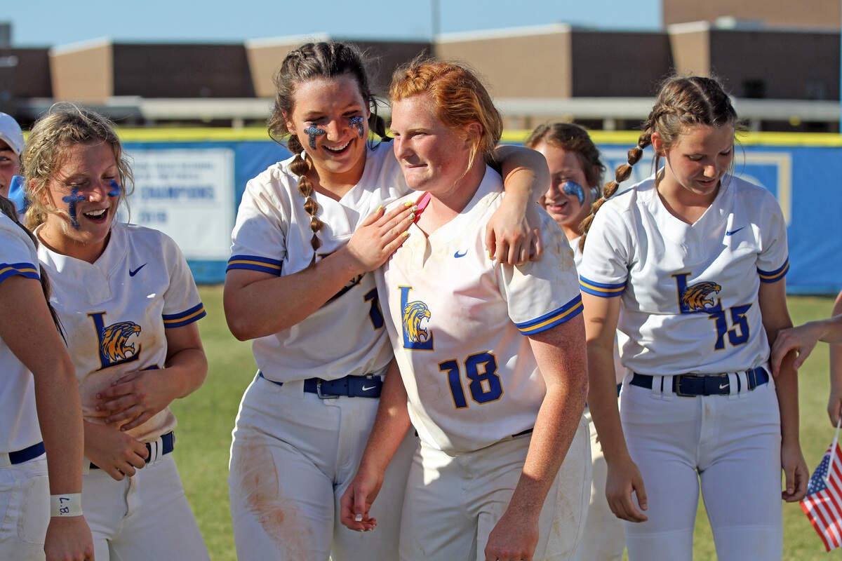 Lexington teammates celebrate Madison Rogers after her game-winning hit Tuesday in the win over Summerville.