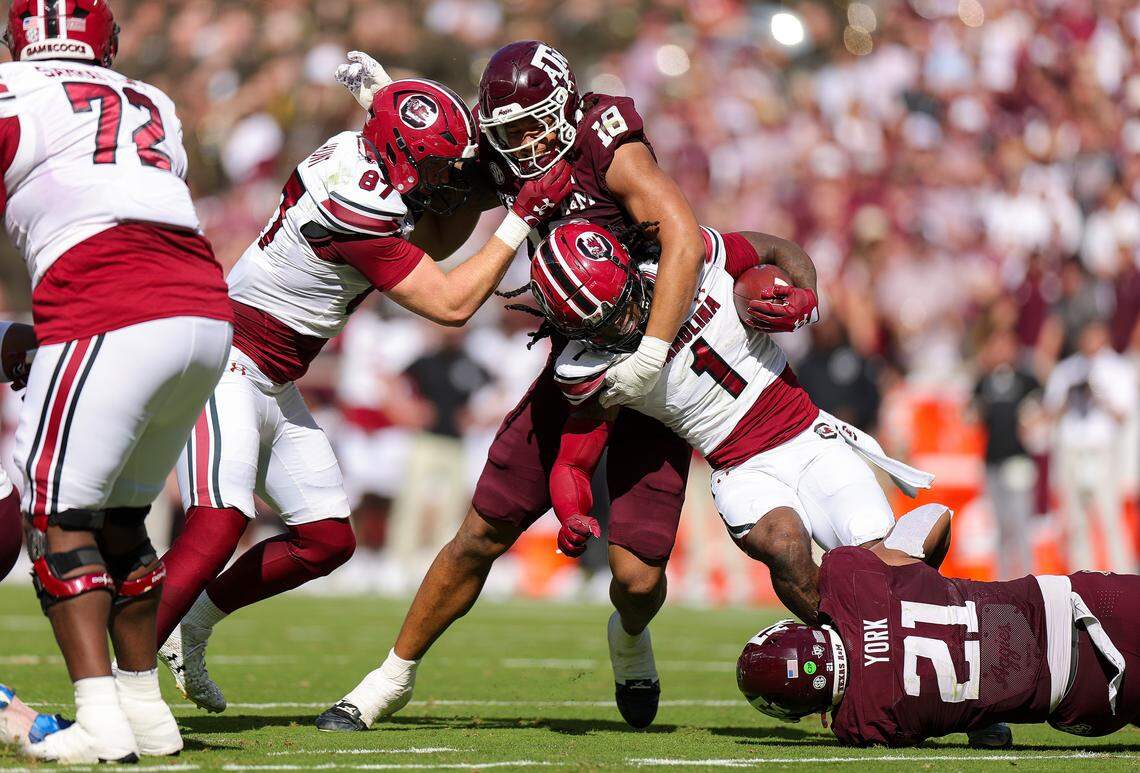 Rahsul Faison #1 of the South Carolina Gamecocks carries as he is tackled by T.J. Searcy #18 of the Texas A&M Aggies during the second quarter at Kyle Field on November 15, 2025 in College Station, Texas. 
