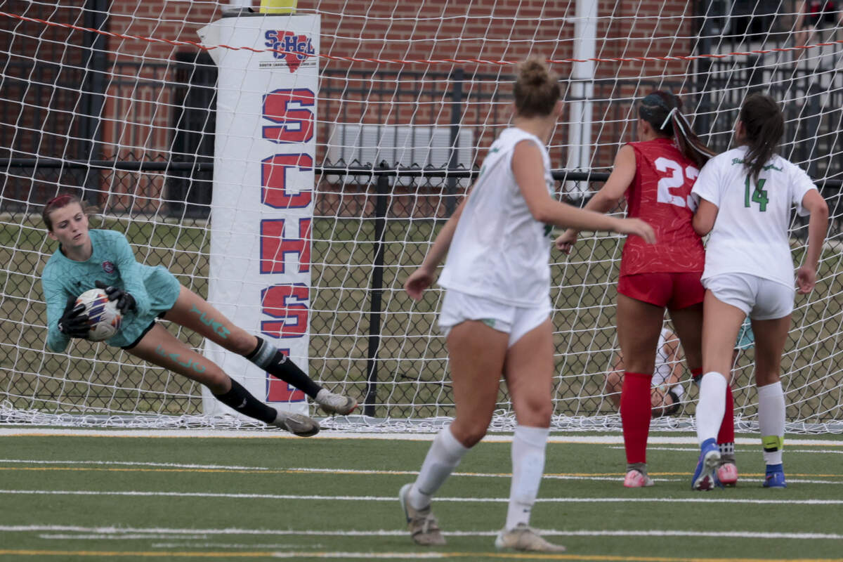 A.C. Flora's Kennedy Bagley (0) makes a save on a shot from Bishop England's Sophia Demarco (39) during the state championship game on Friday, May 22, 2026 at Memorial Stadium in Columbia, SC. AC Flora won in overtime.