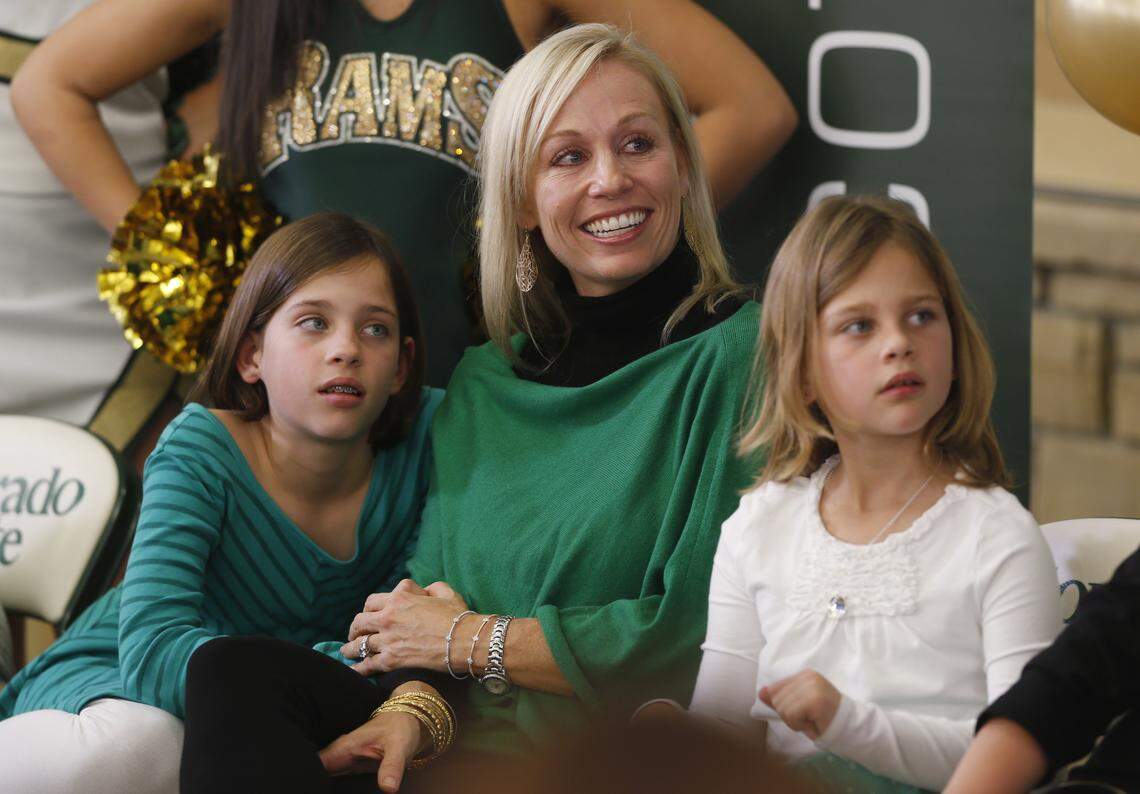 From Dec. 23, 2014: Flanked by her daughter Ava Grace (then 8), left, and daughter Kate (then 7), Lainie Bobo smiles as her husband, Mike Bobo, is introduced as the new head football coach at Colorado State.