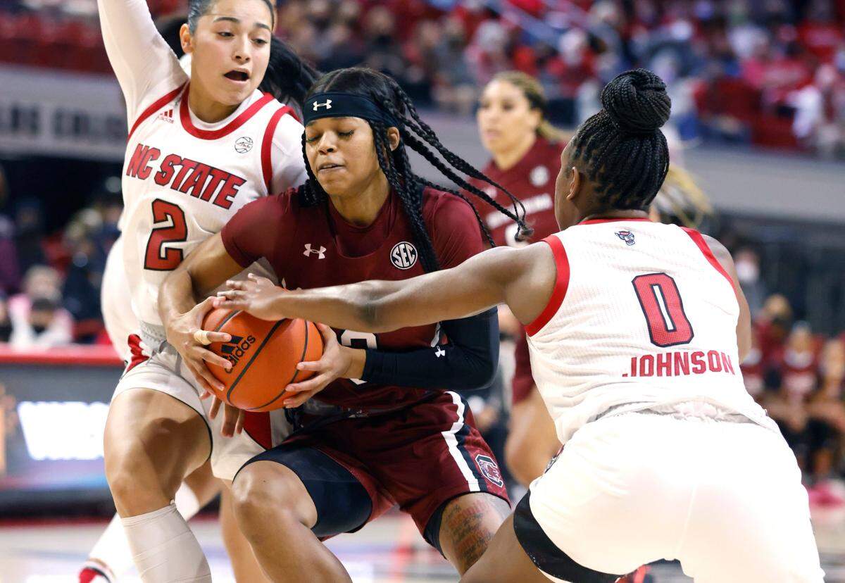 South Carolina’s Destanni Henderson (3) drives between N.C. State’s Raina Perez (2) and Diamond Johnson (0) during the first half of N.C. States game against South Carolina at Reynolds Coliseum in Raleigh, N.C., Tuesday, November 9, 2021.