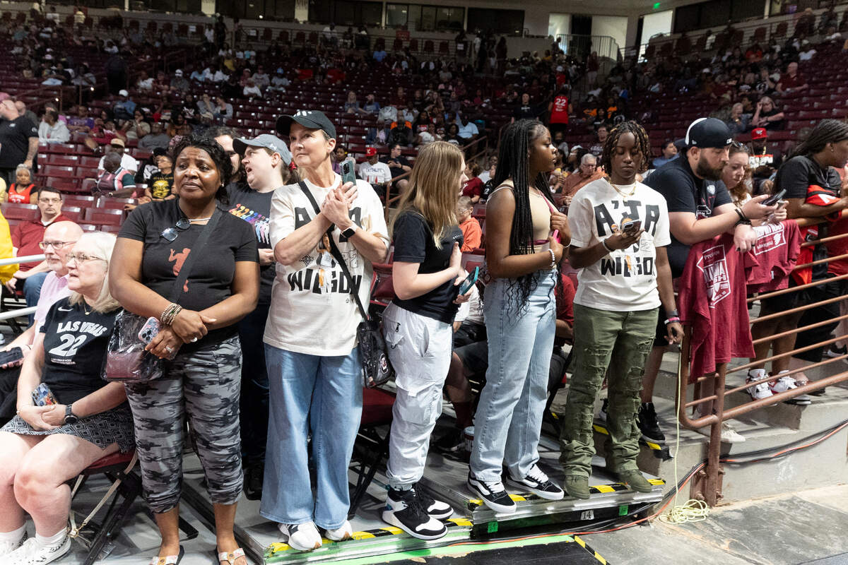 Dayle Sanders of Blythewood, second from left, waits to photograph the Las Vegas Aces as they arrive on court in the Colonial Life Arena.