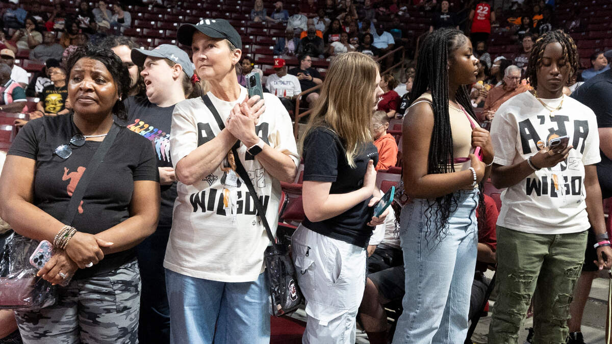 Dayle Sanders of Blythewood, second from left, waits to photograph the Las Vegas Aces as they arrive on court in the Colonial Life Arena.