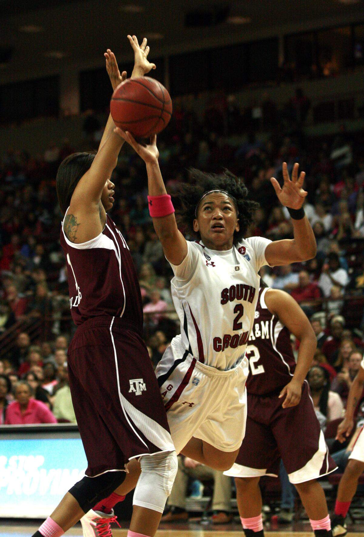 Coverage is tight as Ieasia Walker, leaps to take a shot under the goal Sunday.