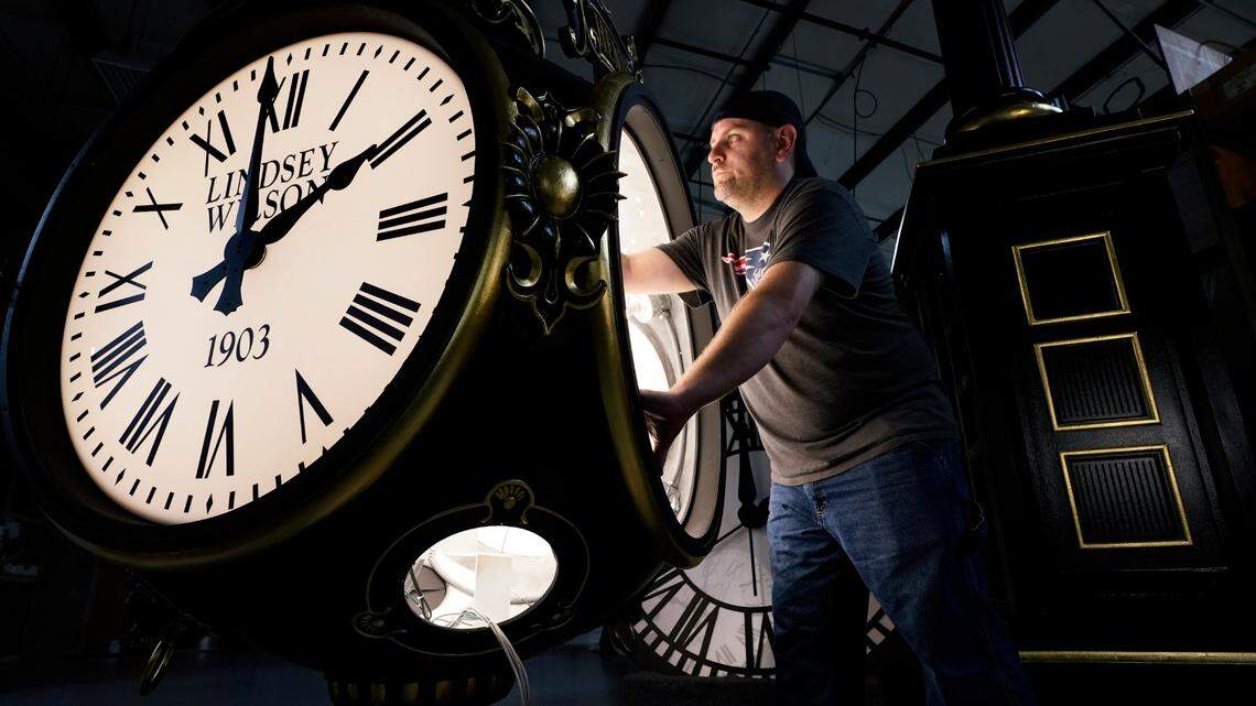 Dan LaMoore works on a Seth Thomas Post Clock at Electric Time Company, Friday, Oct. 23, 2020, in Medfield, Mass. Daylight saving time ends at 2 a.m. local time Sunday, Nov. 1, 2020, when clocks are set back one hour. (AP Photo/Elise Amendola)