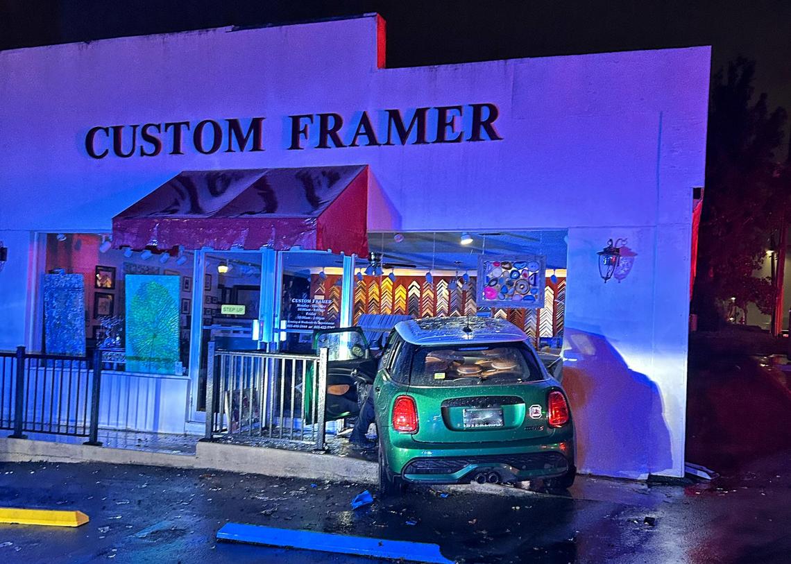 A car crashed into a retail business building.