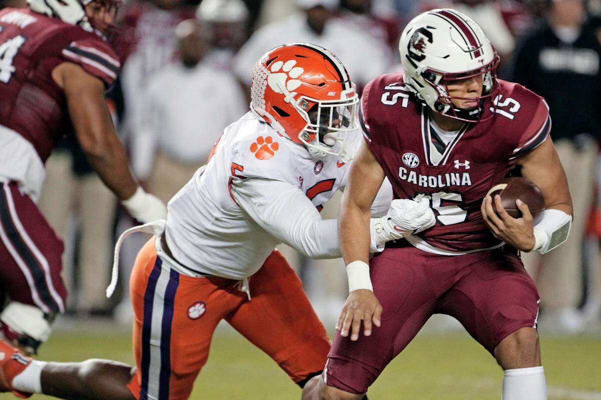South Carolina Gamecocks quarterback Jason Brown (15) is defended by Clemson’s K.J. Henry (5) at Williams-Brice Stadium on Saturday, November 27, 2021.