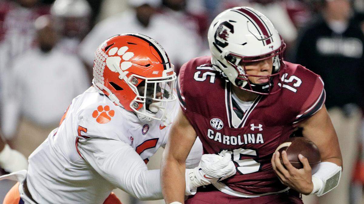 South Carolina Gamecocks quarterback Jason Brown (15) is defended by Clemson’s K.J. Henry (5) at Williams-Brice Stadium on Saturday, November 27, 2021.