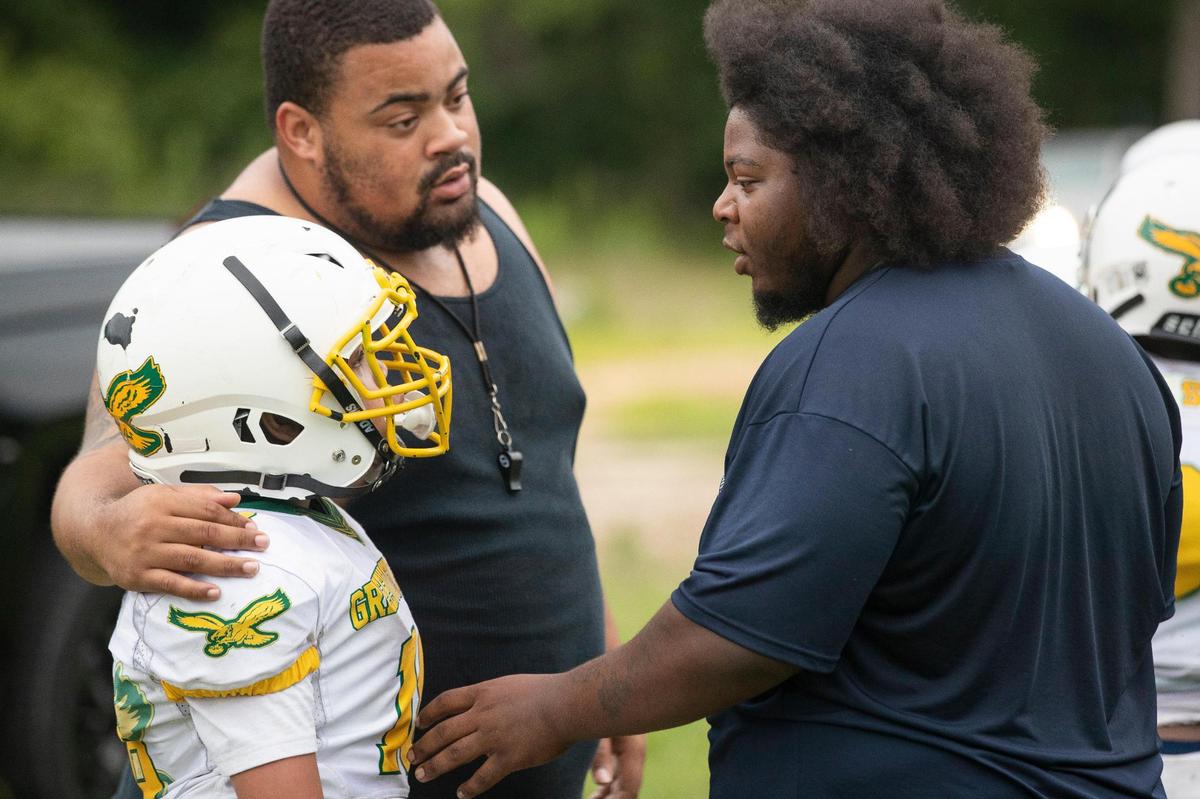 The Greenview Eagles coaches talk with a player during a practice at the former W.G. Sanders Middle School in Columbia, South Carolina on Thursday, July 7, 2022.