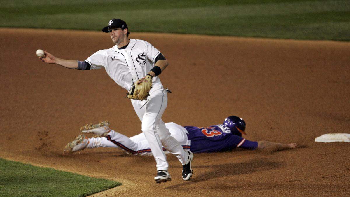 In this file photo, USC’s Scott Wingo throws to first to complete a double play as Clemson’s Brad Miller dives back to the bag.