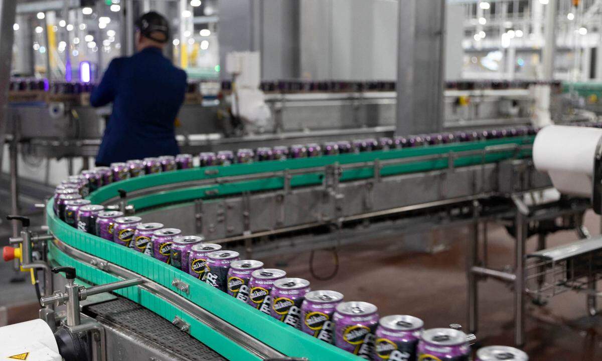 Cans of Mike’s Harder malt beverage run through a filling line at the Mark Anthony Brewery in Columbia. The $490 million plant recently opened and has hired over 300 people.