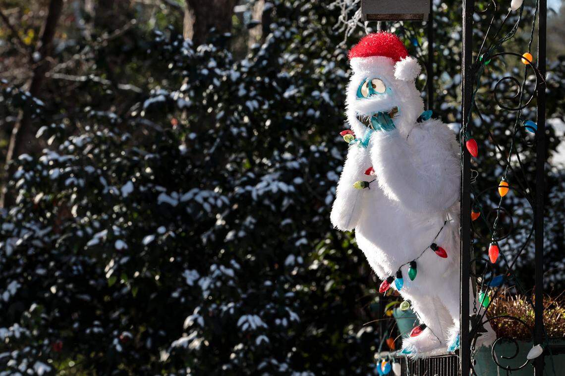 The Abominable Snowman looks out a porch in the South Kilbourne neighborhood after snow blanketed Columbia on Wednesday, Jan. 22, 2025.