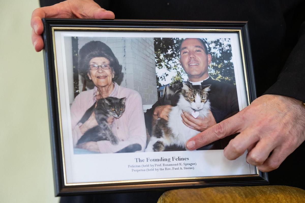 Rev. Paul Sterne shows a picture of two campus cats his ministry took care of at the C. S. Lewis Student Center on the University of South Carolina campus on Wednesday, December 6, 2023.