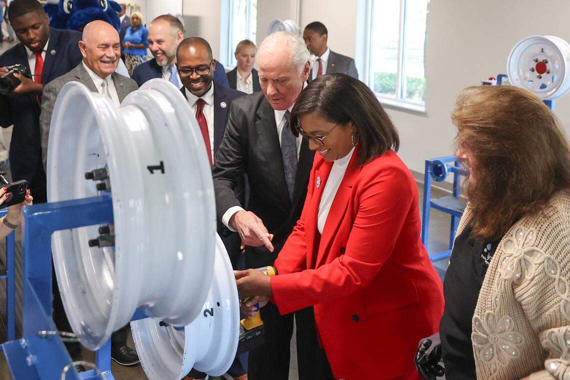 S.C. Gov. Henry McMaster and Richland County councilwoman Jesica Mackey work at a wheel mounting station in the new training area at the Cornerstone Economic Development and Workforce Training Center at Midlands Technical College. The center is being used to screen applicants for Scout Motors.