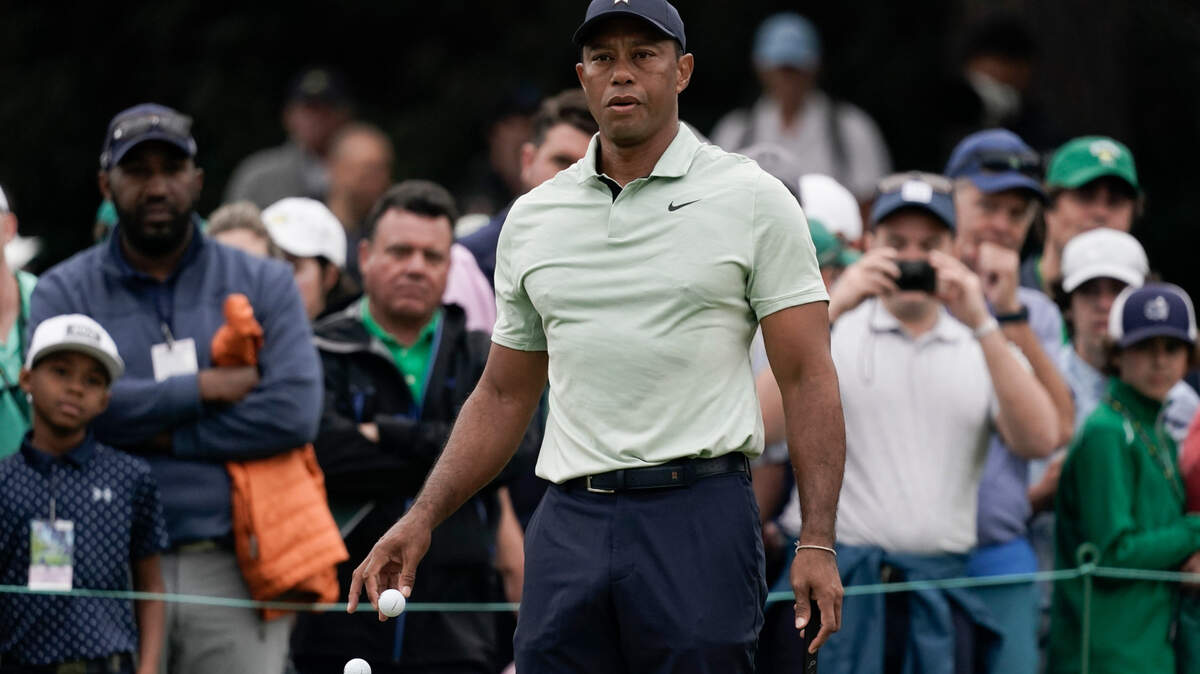 Tiger Woods drops golf balls on the driving range during a practice round for the Masters golf tournament on Tuesday in Augusta.