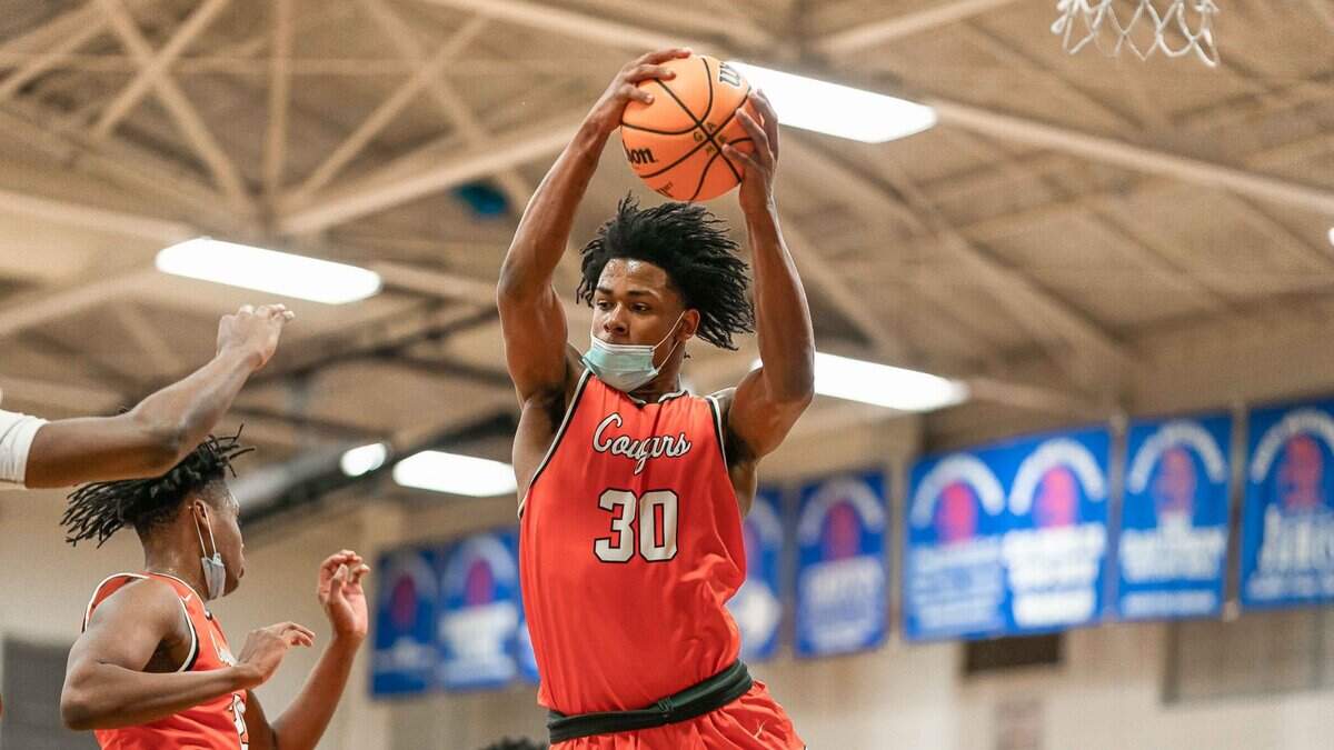 Daniel Hankins-Sanford (30) grabs a rebound during a game in February.