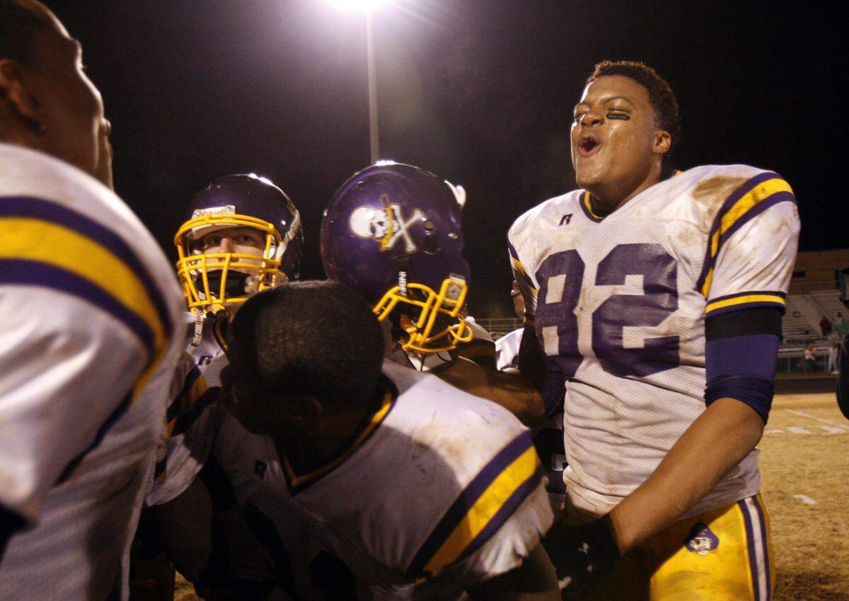LER-RIV11.SP.11.24.06.JTA Riverside’s Weslye Saunders celebrates his team’s 27-20 victory in Friday night’s playoff game against Leesville Rd. (News and Observer Staff Photo by Jason Arthurs)