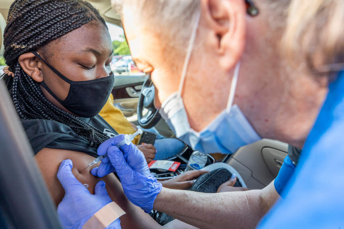 Ceigan Carter, 13, receives the coronavirus vaccine from Mae Parker Sparrow, a registered nurse at Prisma Health, at W.A. Perry Middle School on Saturday, May 22, 2021. Recently the Pfizer vaccine was approved for children.
