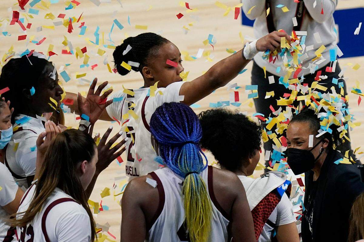 South Carolina head coach Dawn Stanley, right, celebrates with her team after their win over Texas in a college basketball game in the Elite Eight round of the women’s NCAA tournament at the Alamodome in San Antonio, Tuesday, March 30, 2021.