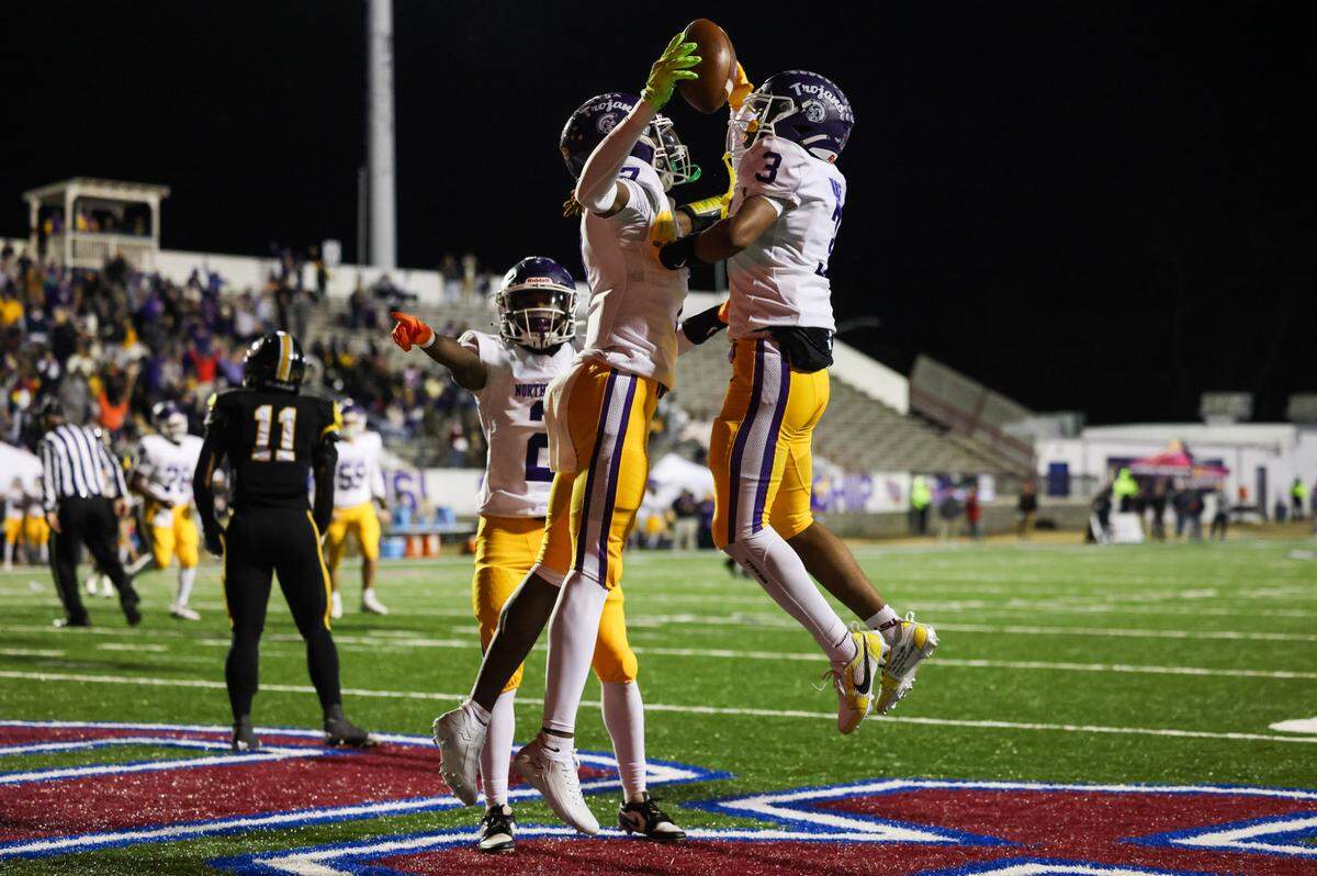 TaDarrian Knox (7) of Northwestern celebrates with Kameron Vance (3) following a touchdown during the Class 5A-D2 football state championship game at Oliver Dawson Stadium in Orangeburg on Saturday, December 14, 2024.