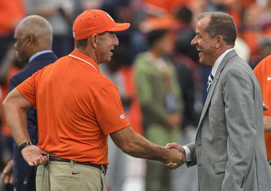 Sep 30, 2023; Syracuse, New York, USA; Clemson Tigers head coach Dabo Swinney, left, and ACC Commissioner Jim Phillips talk before the game with the Syracuse Orange at JMA Wireless Dome. Mandatory Credit: Ken Ruinard-USA TODAY Sports