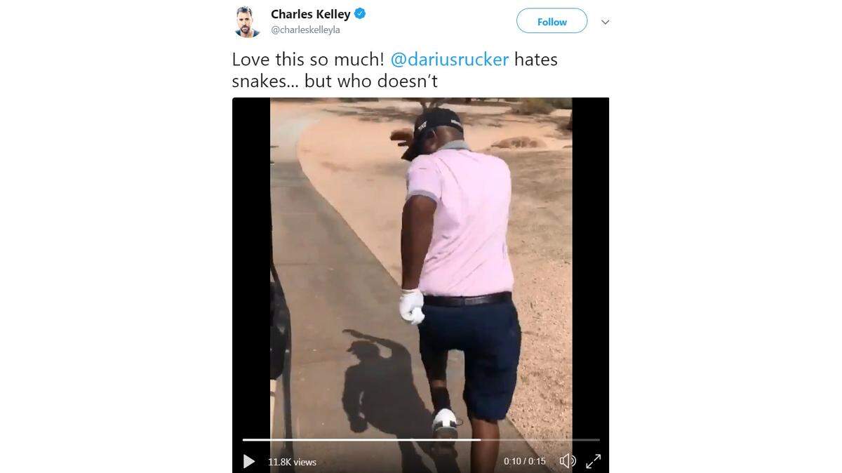 In this screenshot, country music star Darius Rucker is running away from a snake next to his golf cart.