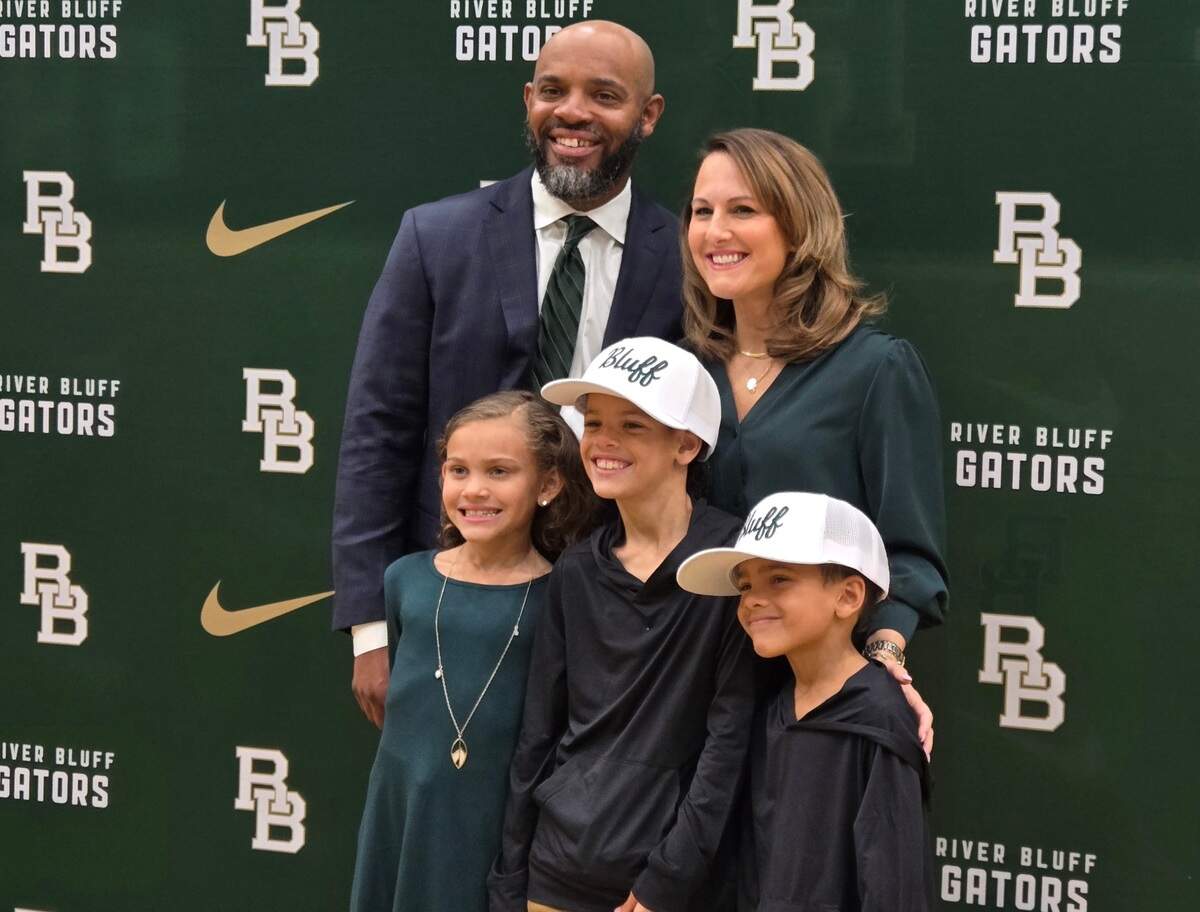 New River Bluff football coach Perry Parks, his wife and children pose for a photo as Parks was introduced as the school’s new coach on March 26, 2025.