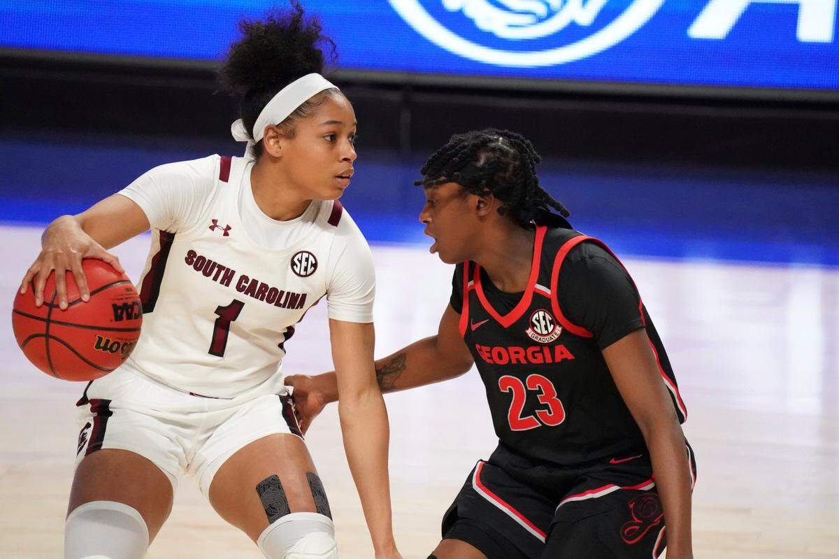 South Carolina guard Zia Cooke (1) dribbles next to Georgia guard Que Morrison (23) during the first half of an NCAA college basketball game Sunday, March 7, 2021, during the Southeastern Conference tournament final in Greenville, S.C.