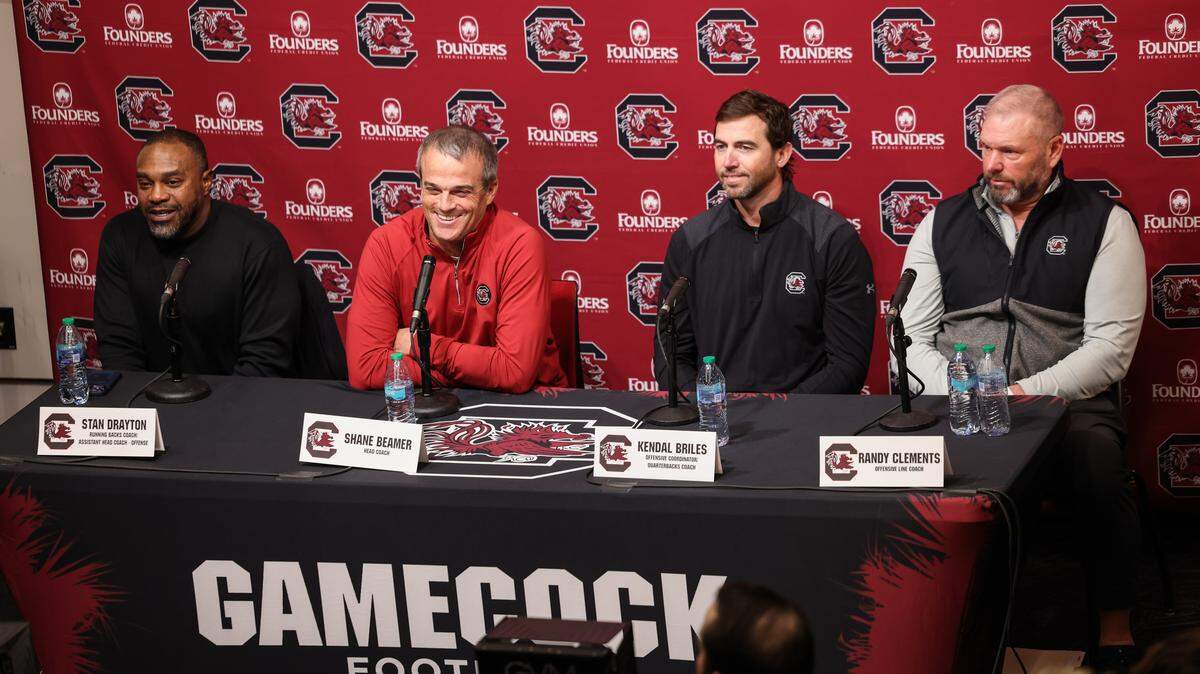 South Carolina running backs coach Stan Drayton, head coach Shane Beamer, offensive coordinator Kendal Briles and offensive line coach Randy Clements are seen during a press conference in Columbia on Friday, December 12, 2025.