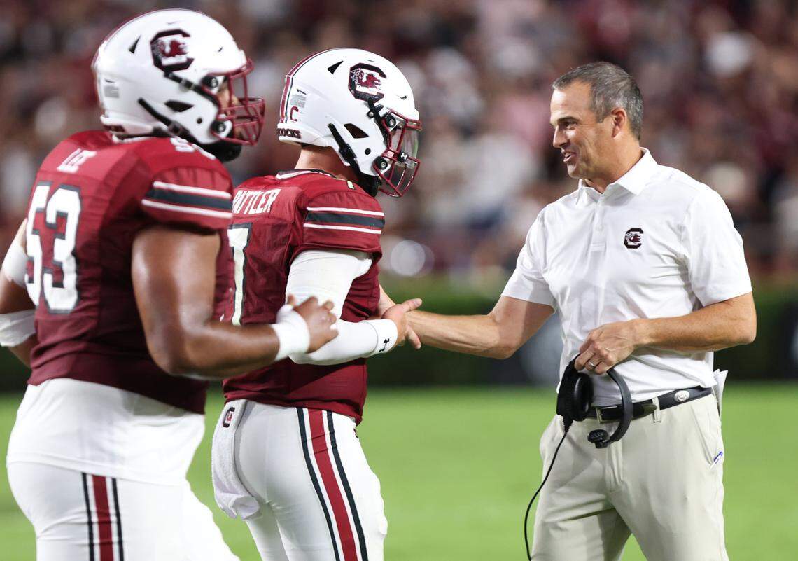 South Carolina quarterback Spencer Rattler (7) is congratulated by head coach Shane Beamer after scoring during the first half of the Gamecocks’ game at Williams-Brice Stadium in Columbia on Saturday, September 9, 2023.