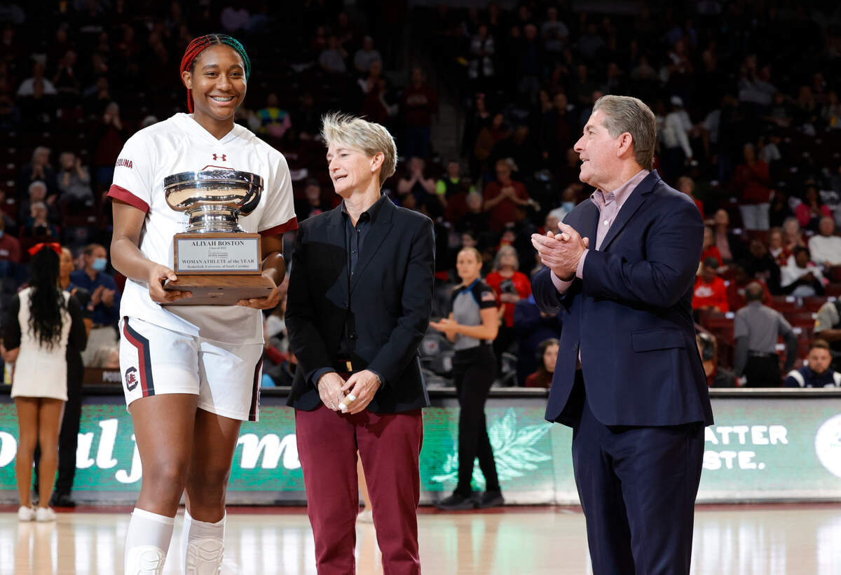 Jenny Gilger presents South Carolina’s Aliyah Boston (4) with the Honda Cup in the Colonial Life Arena before the Gamecocks take on Charleston’s Southern on Sunday, Dec. 18, 2022.