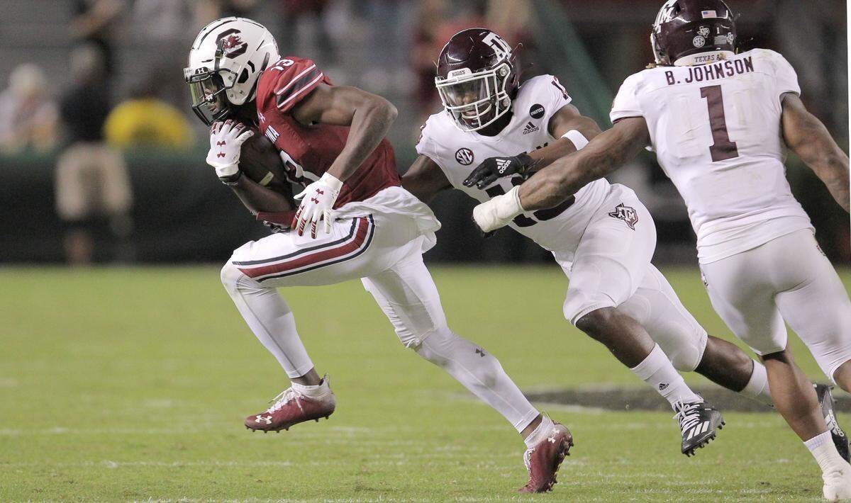 South Carolina wide receiver Shi Smith (13) tries to break away from two Texas A&M players in 2020. Smith was drafted by the Carolina Panthers in the sixth round Saturday.